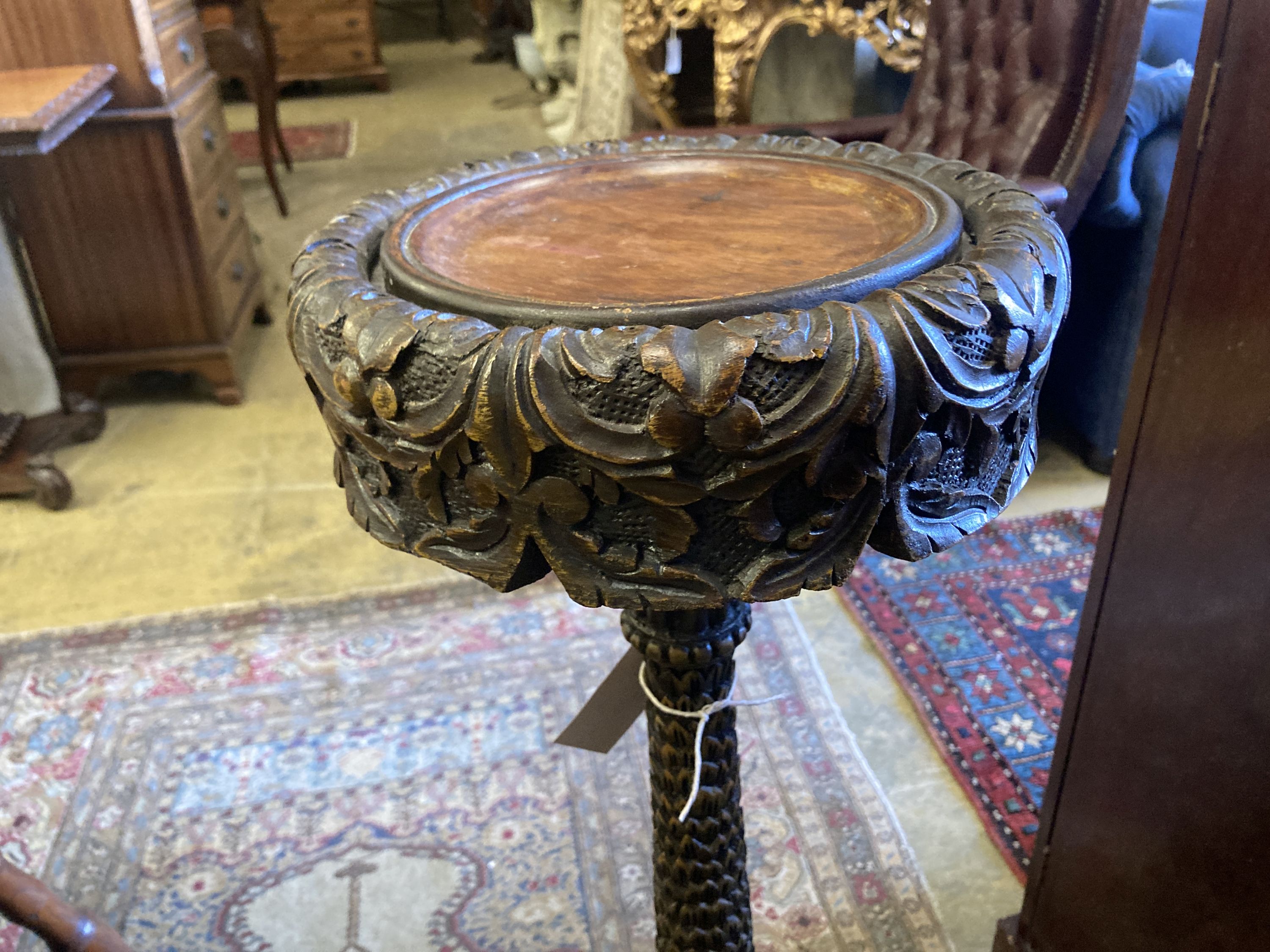 A 19th century Burmese carved hardwood jardiniere stand, height 95cm